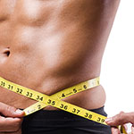 A close-up of a person's midsection with a yellow measuring tape around the waist, against a white background.