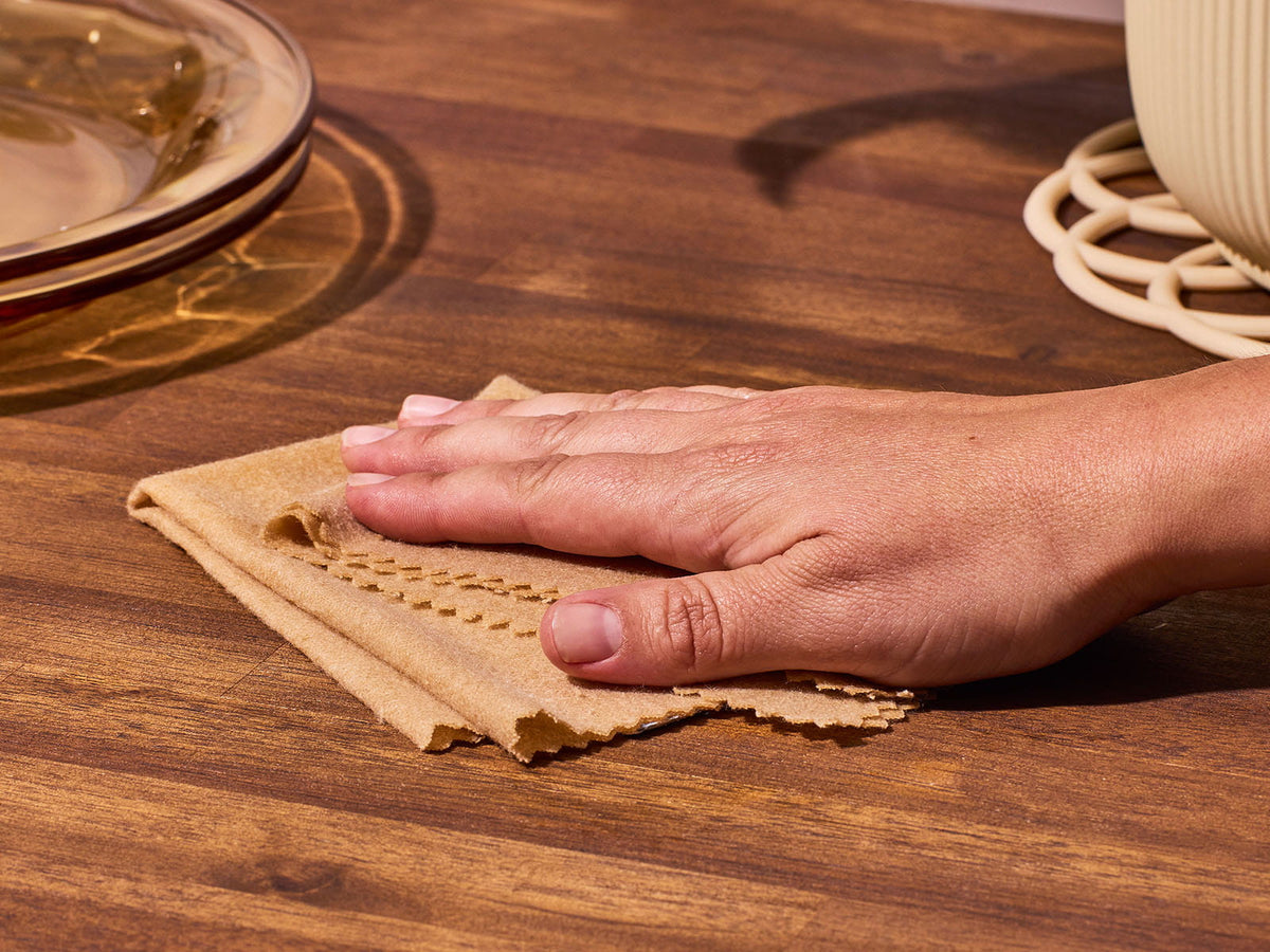 image of someone wiping a wooden table with a Snap Cloth