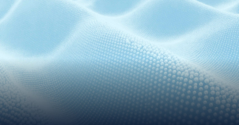 A close-up of a light blue textured material with a wavy, undulating surface and a fine dotted pattern.