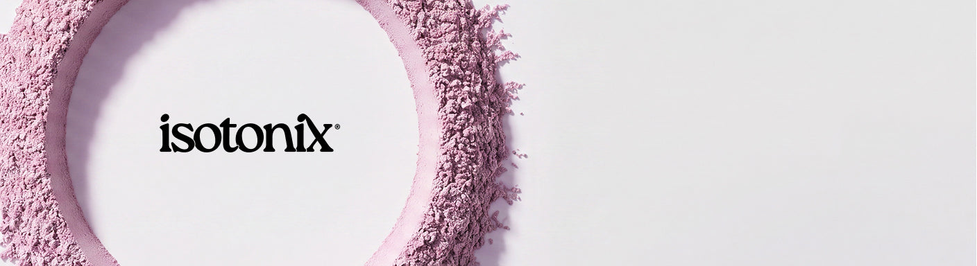 Isotonix brand logo in black text centered inside a circular frame made of light pink cosmetic powder, set against a very light gray background.