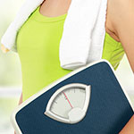 A close-up lifestyle shot of a person in a lime green tank top with a white towel on their shoulder, holding a navy blue digital scale in front of them.