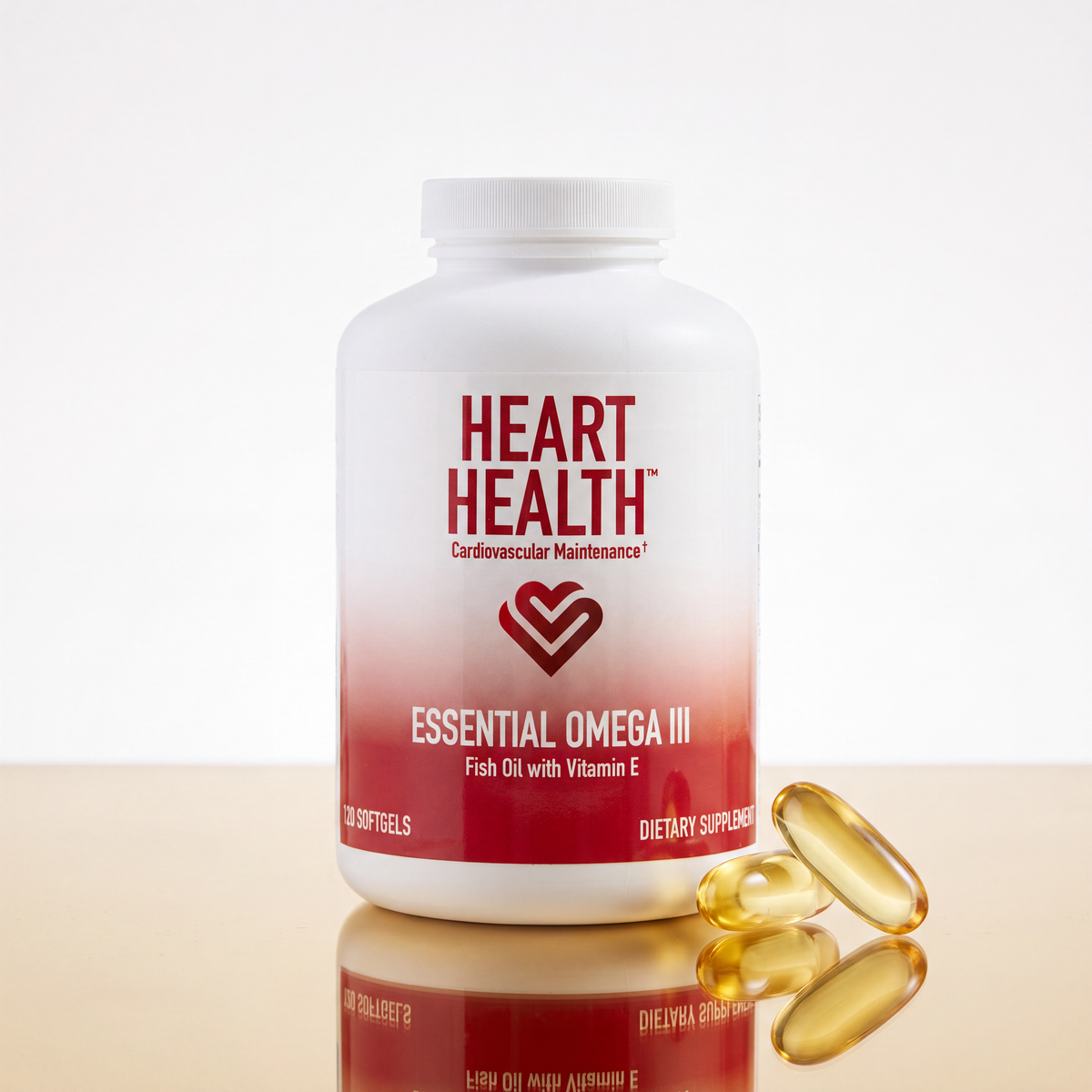 A white bottle of Heart Health Essential Omega III fish oil dietary supplement with a red gradient label, shown on a light wooden surface with three golden softgel capsules in front against a white background.
