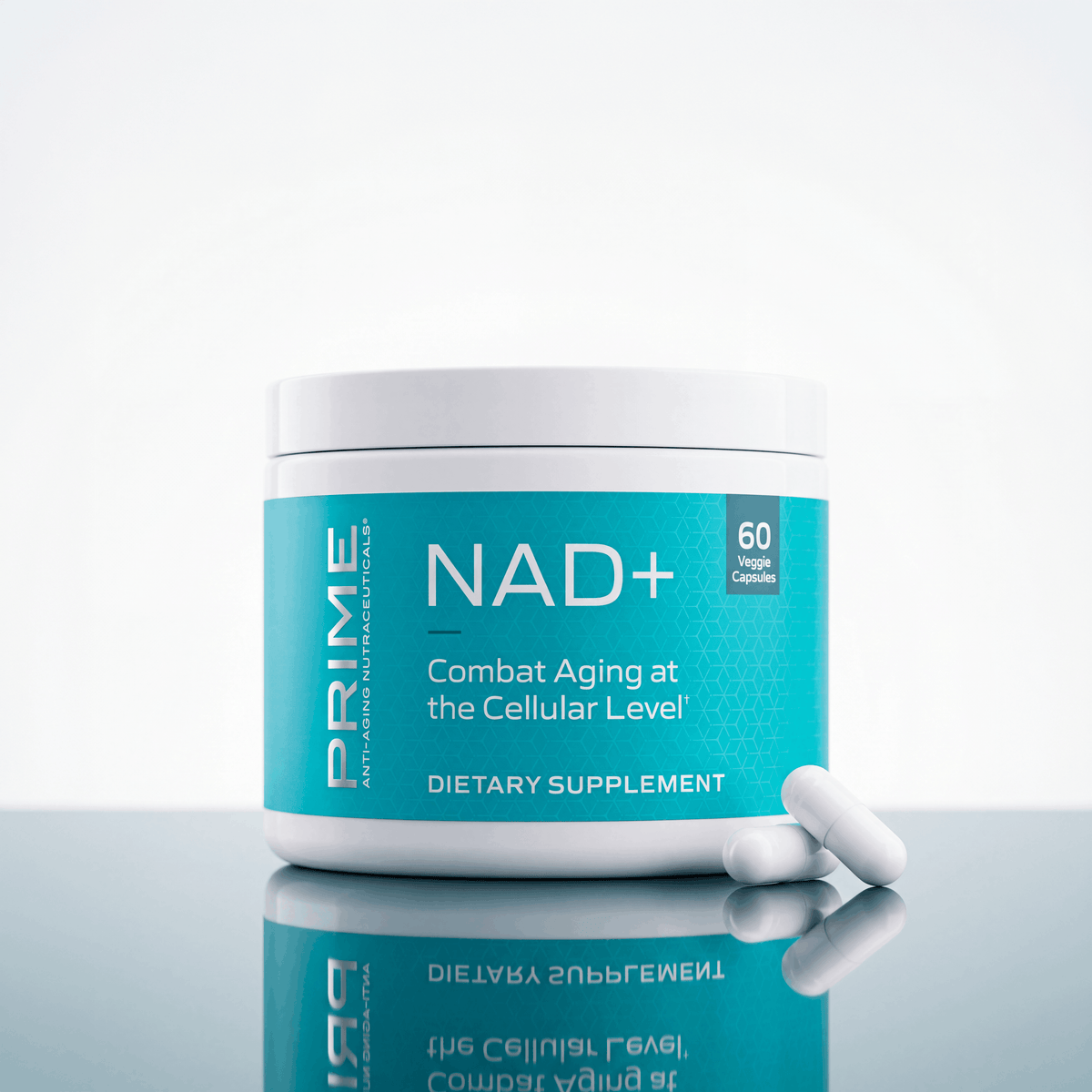 A white plastic jar of PRIME NAD+ dietary supplement with a bright teal label, shown on a reflective light gray surface with two white capsules in front.