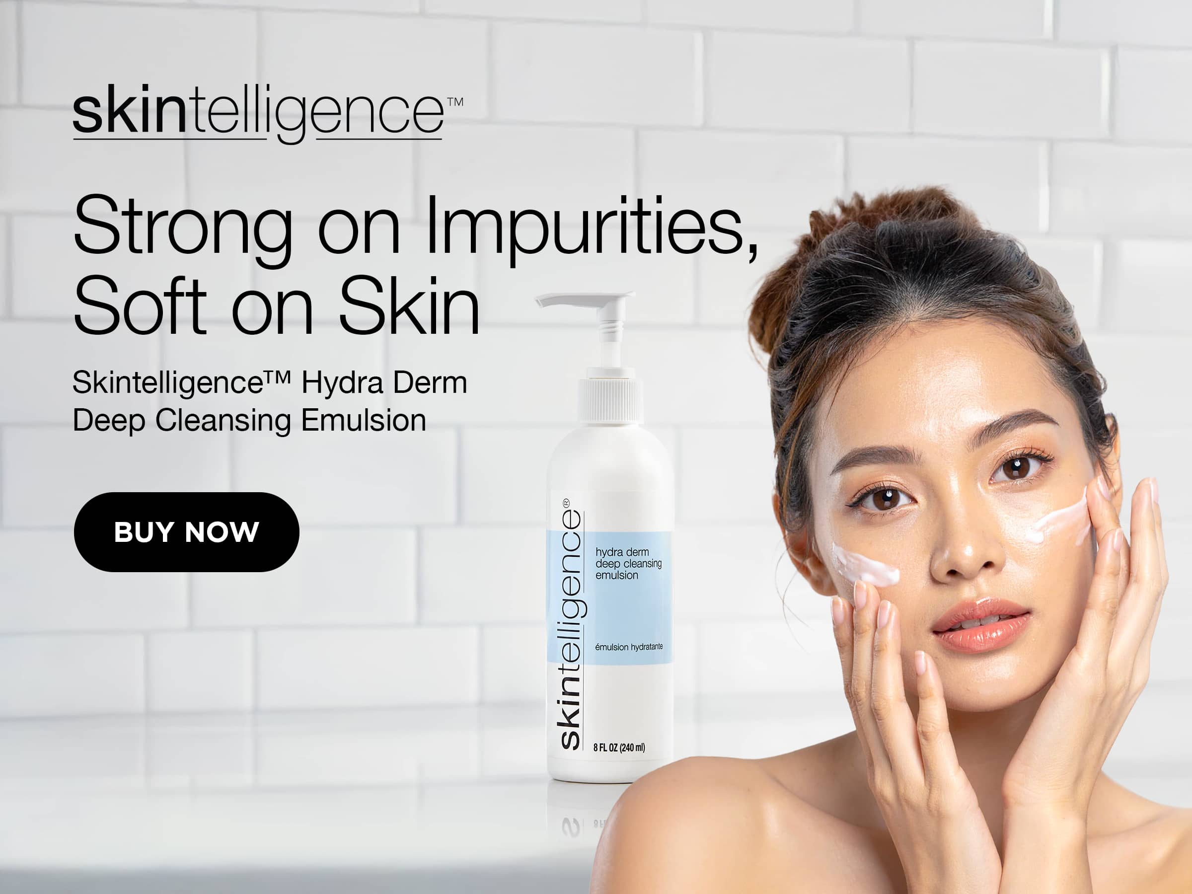 Skintelligence Hydra Derm Deep Cleansing Emulsion bottle shown beside a woman applying cream to her face in a bright bathroom setting with white subway tile.