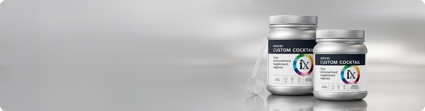 Two white supplement jars labeled 'EXCITINGLY CUSTOM COCKTAILS' with a small white scoop beside them, set against a reflective gray gradient background.