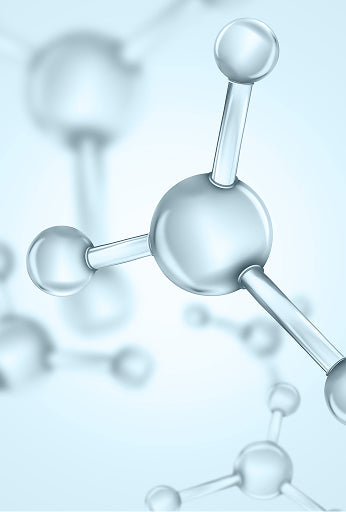 A 3D molecular model with metallic silver spheres and connecting rods, shown in sharp focus against a soft, out-of-focus light blue background.